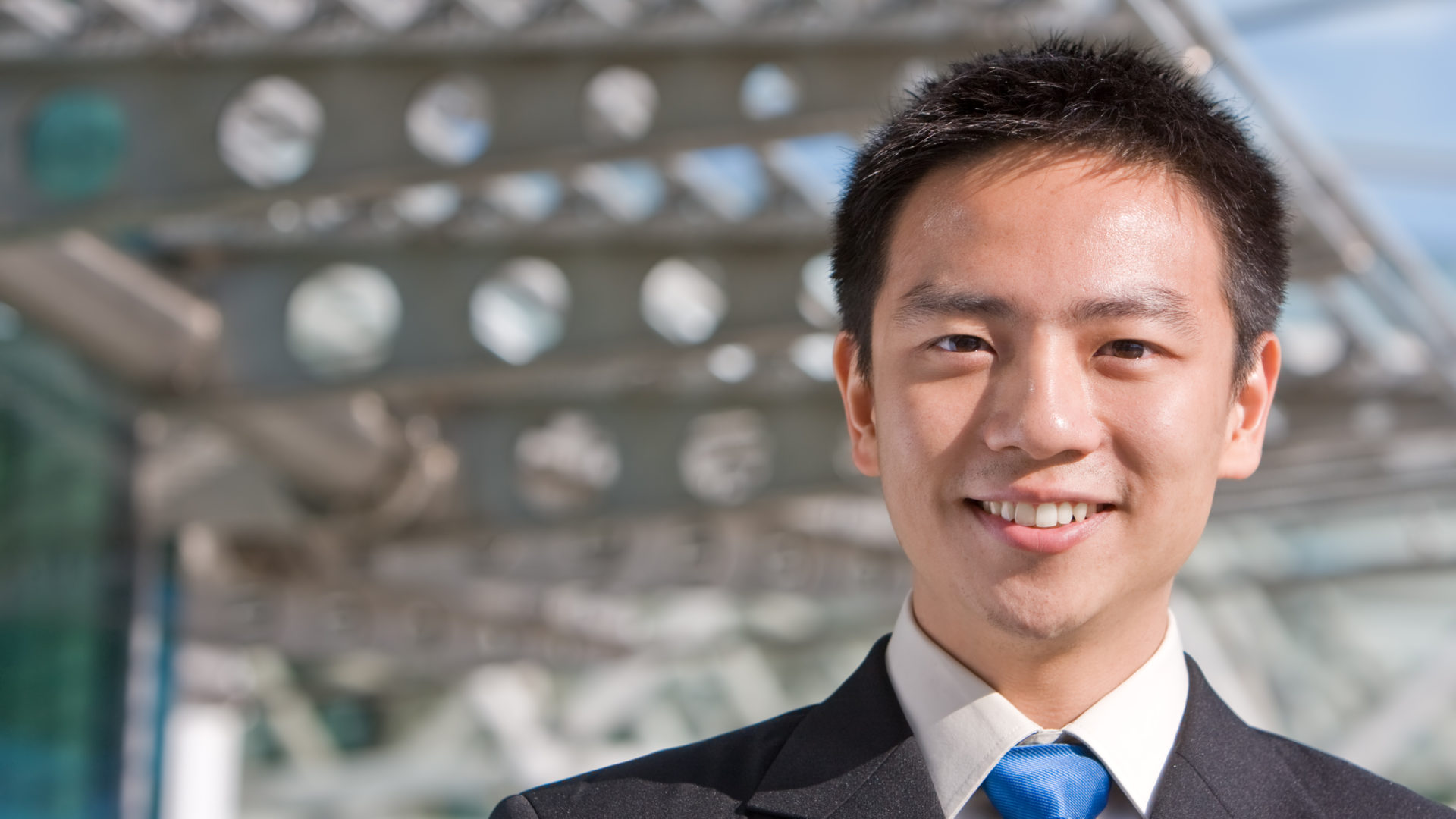 Asian chinese business man Good looking asian business man standing with formal suit.